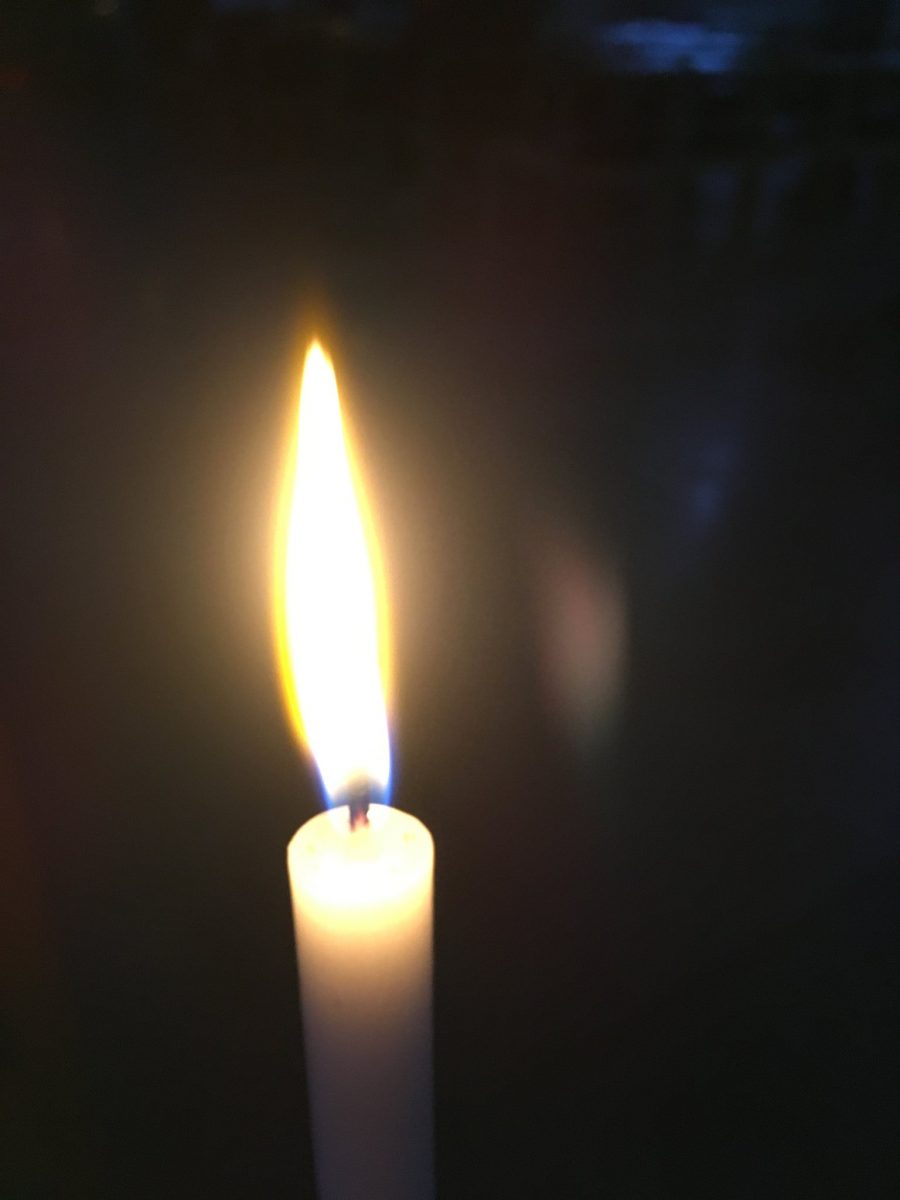 A candle flame in the dark